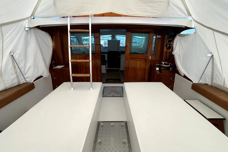 Slide: The Image of Interior view of a 1982 Torres Boat Mfg 43, featuring wooden finishes and a ladder. - 43