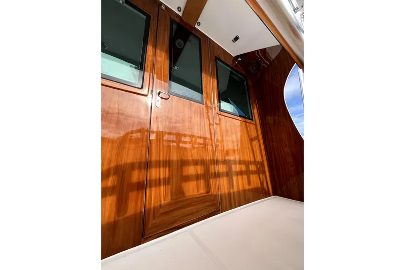 Slide: The Image of Polished wooden cabin doors on a 1982 Torres Boat Mfg 43 model. - 44