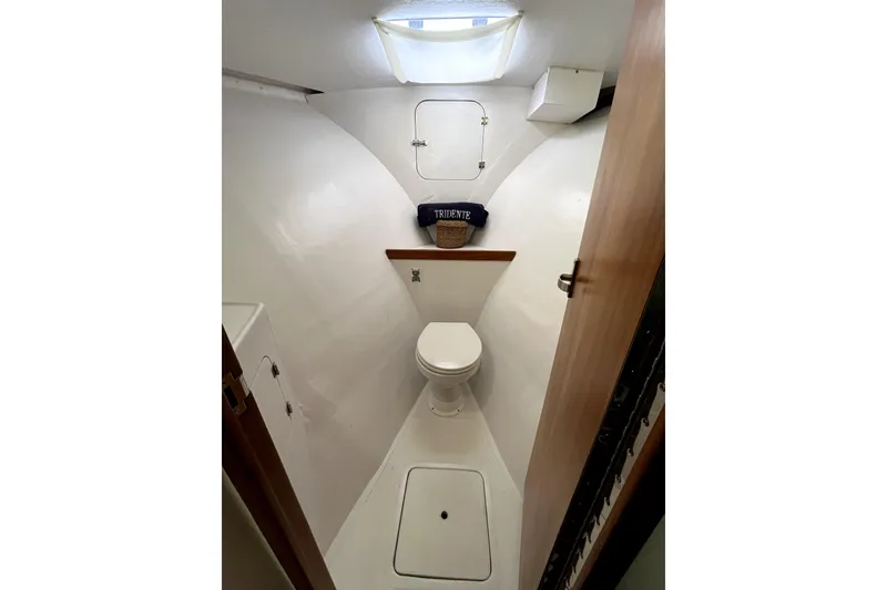 Slide: The Image of 1982 Torres Boat Mfg 43 interior bathroom with toilet and storage compartments. - 7