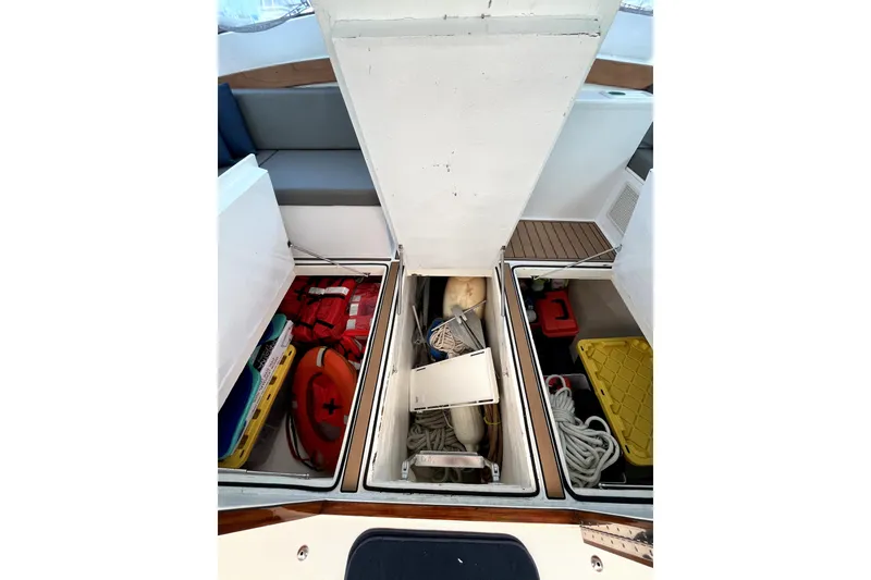Slide: The Image of Storage compartments on a 1982 Torres Boat Mfg 43, containing life jackets, ropes, and safety equipment. - 18