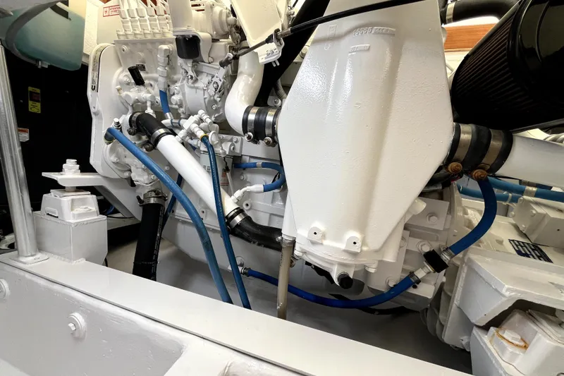 Slide: The Image of Engine compartment of a 1982 Torres Boat Mfg 43, showcasing mechanical components and hoses. - 24