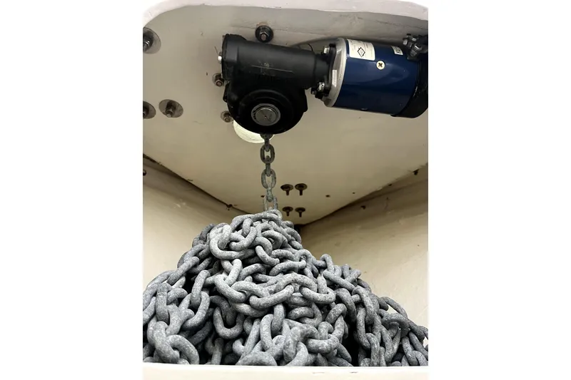 Slide: The Image of Custom 1982 model 43 boat named "Tridente" on clear blue water near a rocky shoreline. - 4