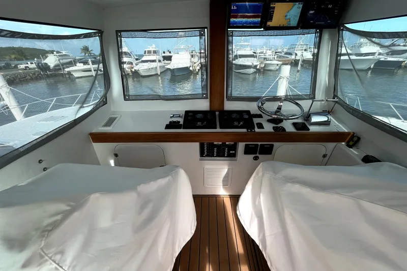 Slide: The Image of Interior helm of 1982 Torres Boat Mfg 43, featuring wood paneling and navigation equipment. - 40