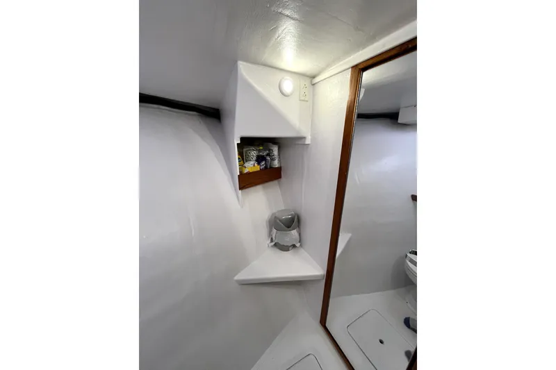 Slide: The Image of Custom 1982 model 43 boat on clear blue water, sunny day, distant islands. - 5