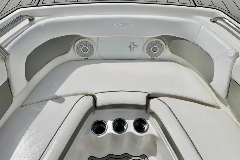 Slide: The Image of 2014 Tidewater 230 LXF boat interior with cushioned seating and built-in speakers. - 10