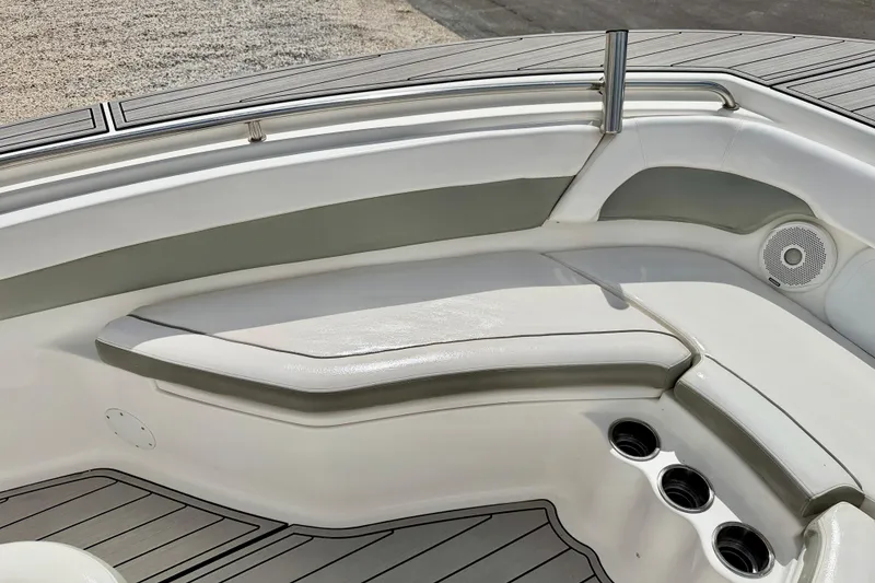Slide: The Image of 2014 Tidewater 230 LXF boat interior with cushioned seating and cup holders. - 11