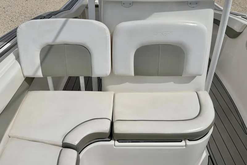 Slide: The Image of 2014 Tidewater 230 LXF boat seating with white cushions and sleek design. - 13