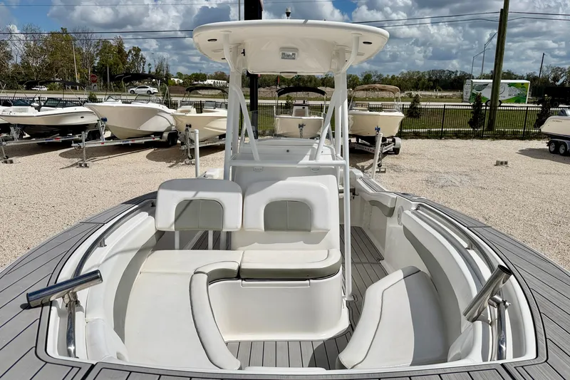 Slide: The Image of 2014 Tidewater 230 LXF boat with spacious seating, displayed outdoors under a cloudy sky. - 15