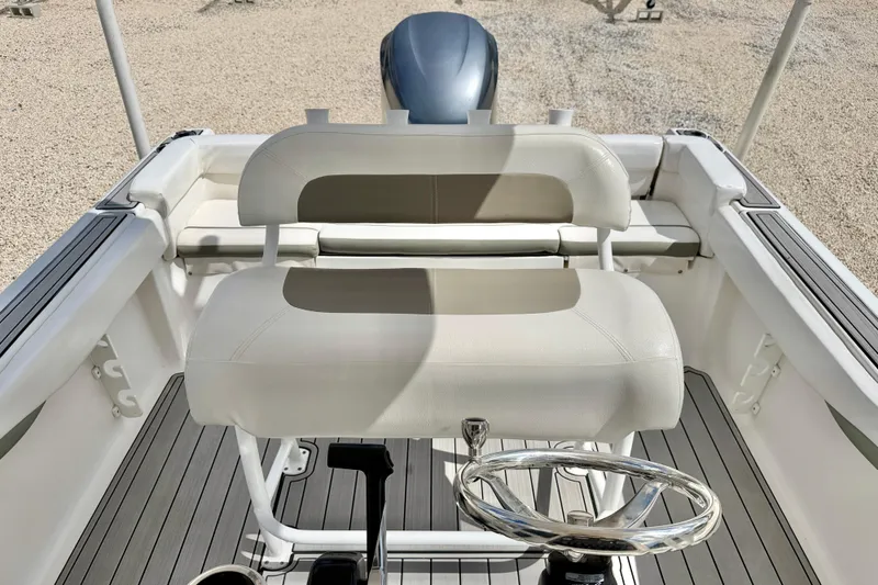 Slide: The Image of 2014 Tidewater 230 LXF boat interior with steering wheel and seating. - 17