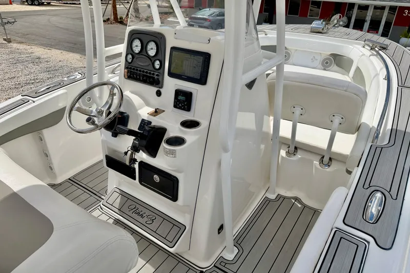 Slide: The Image of 2014 Tidewater 230 LXF boat interior with steering console and seating. - 18