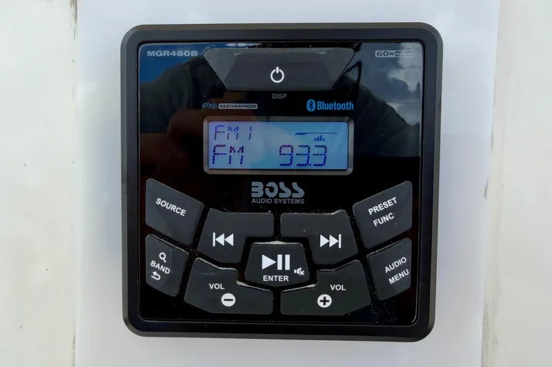Slide: The Image of Boat audio system display on 2014 Tidewater 230 LXF, showing FM 93.3. - 23