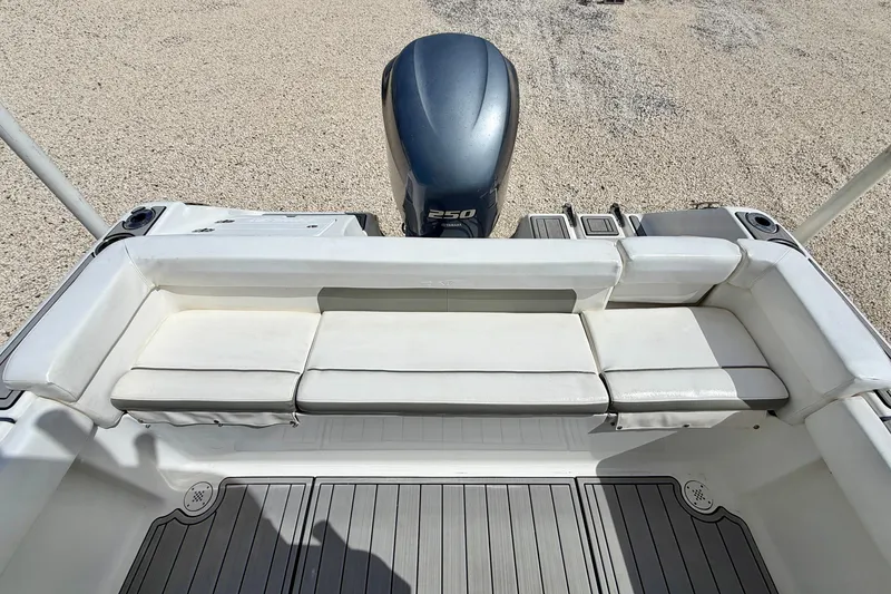 Slide: The Image of 2014 Tidewater 230 LXF boat with cushioned seating and powerful outboard motor. - 25