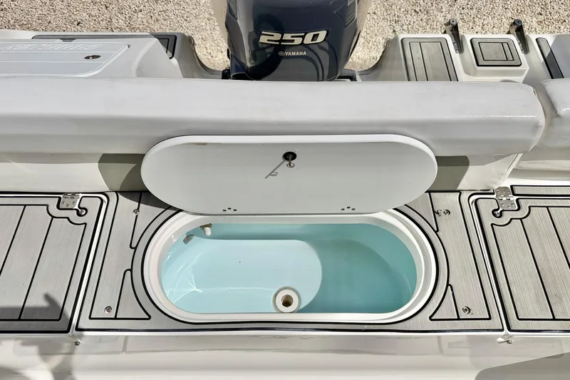 Slide: The Image of 2014 Tidewater 230 LXF boat with open livewell and Yamaha 250 engine. - 27