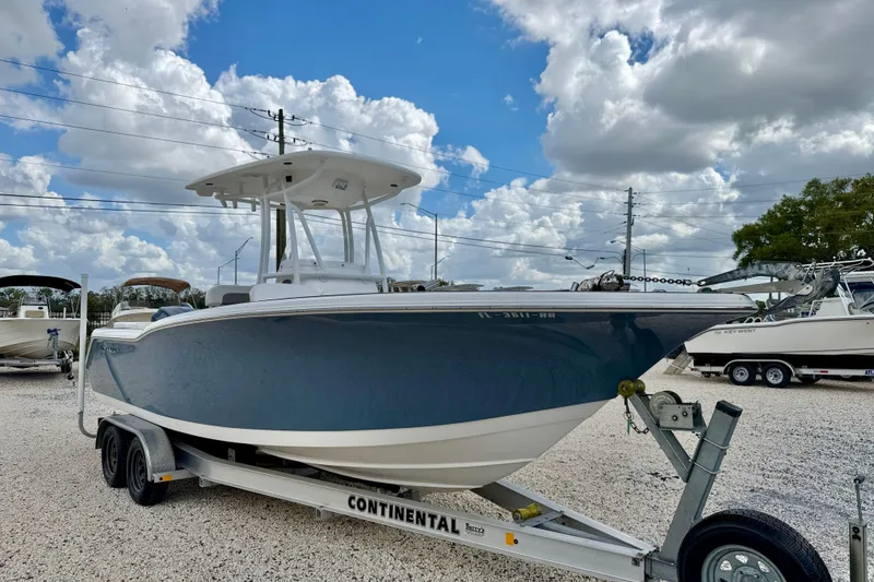 Slide: The Image of 2014 Tidewater 230 LXF boat on trailer under cloudy sky. - 3
