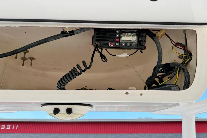 Slide: The Image of 2014 Tidewater 230 LXF boat electronics compartment with radio and wiring. - 30