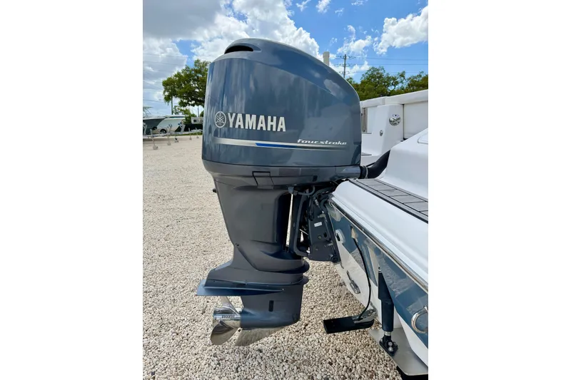 Slide: The Image of Yamaha four-stroke outboard motor on 2014 Tidewater 230 LXF boat, parked on gravel. - 32
