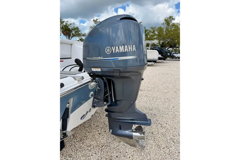 Slide: The Image of 2014 Tidewater 230 LXF with Yamaha outboard motor, parked on gravel. - 34