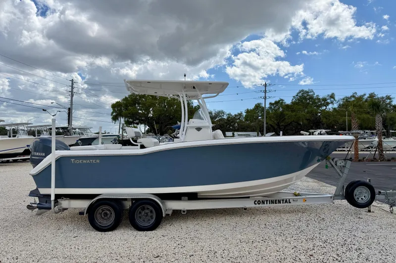 Slide: The Image of 2014 Tidewater 230 LXF boat on trailer under cloudy sky. - 4