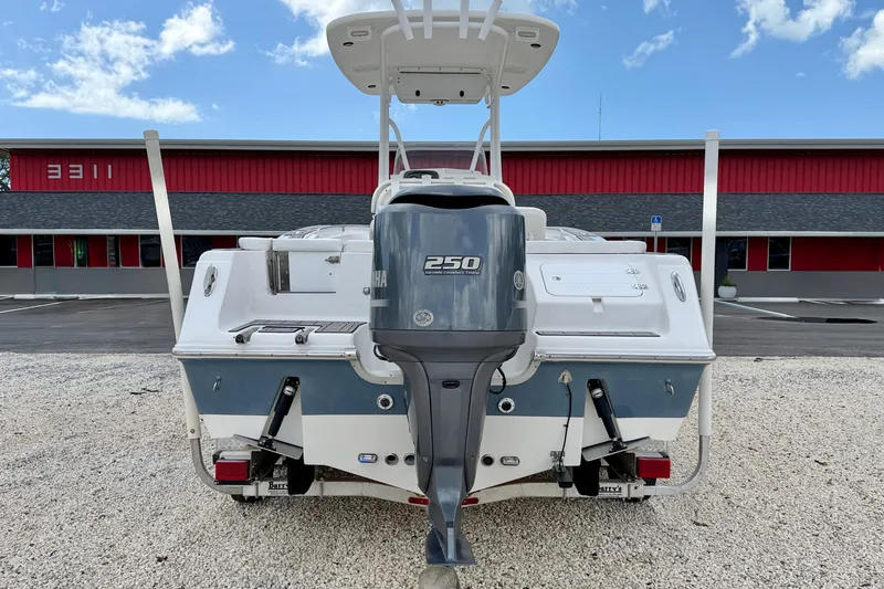 Slide: The Image of 2014 Tidewater 230 LXF boat with Yamaha 250 outboard motor, parked on gravel. - 6