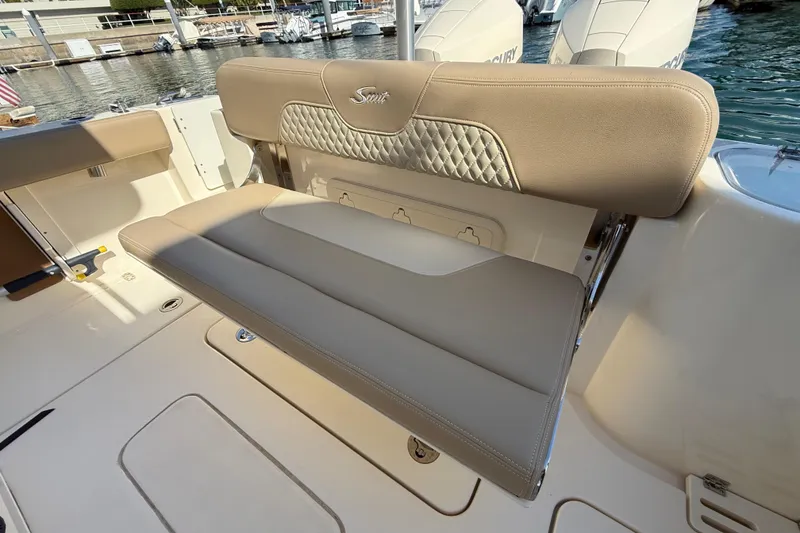 Slide: The Image of 2024 Scout 260 LXF boat with beige seating and quilted backrest detail. - 13