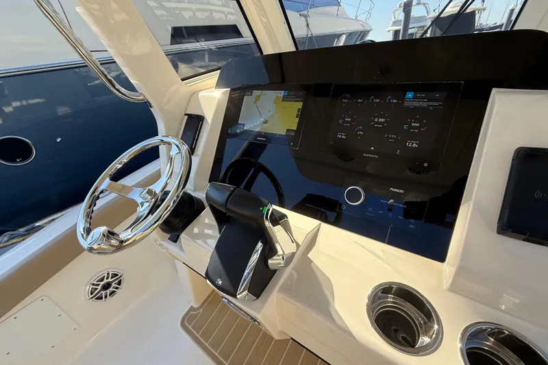 Slide: The Image of 2024 Scout 260 LXF boat dashboard with modern navigation and control systems. - 22