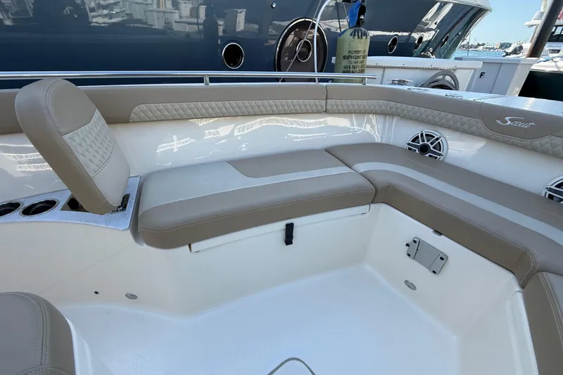 Slide: The Image of 2024 Scout 260 LXF boat interior with beige seating and cup holders. - 31