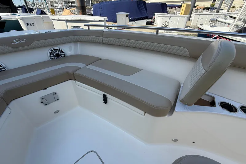 Slide: The Image of 2024 Scout 260 LXF boat interior with cushioned seating and speaker system. - 32