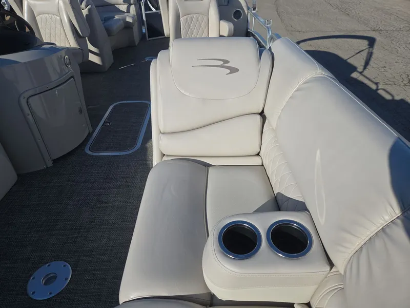 Slide: The Image of Interior of a 2015 Bennington 2250 GSR with beige leather seating. - 11