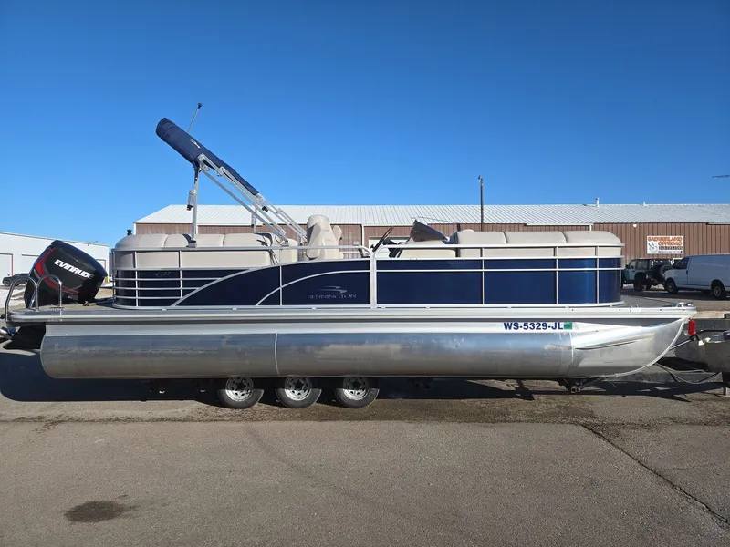 Slide: The Image of 2015 Bennington 2250 GSR pontoon boat in parking lot. - 5