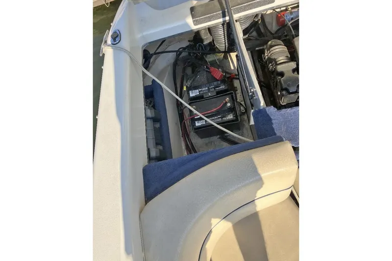 Slide: The Image of 2000 Sea Ray 230 Signature boat interior showing battery compartment and engine components. - 9