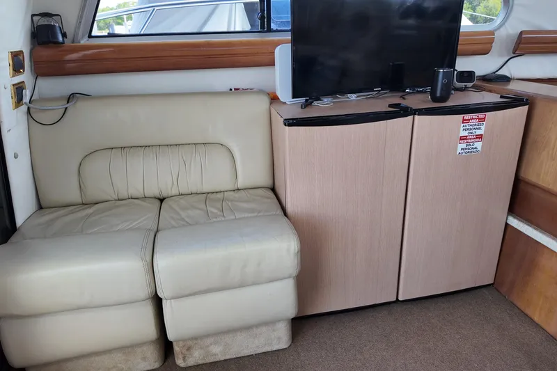 Slide: The Image of Interior of 2007 Cranchi Atlantique 40 yacht with beige seating and a small entertainment area. - 12