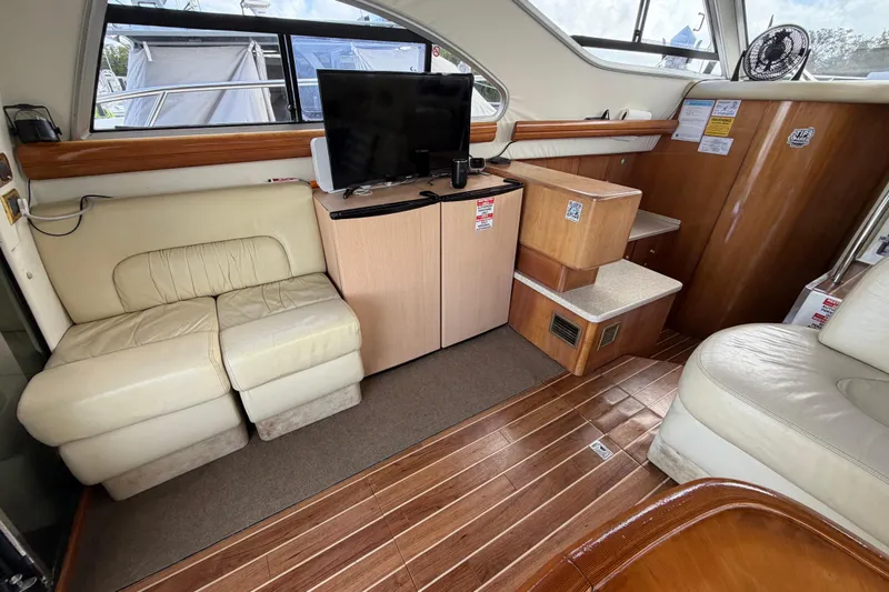 Slide: The Image of Interior of 2007 Cranchi Atlantique 40 yacht with seating, TV, and wooden flooring. - 14