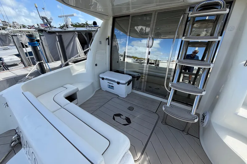 Slide: The Image of 2007 Cranchi Atlantique 40 yacht deck with seating, ladder, and cooler. - 7