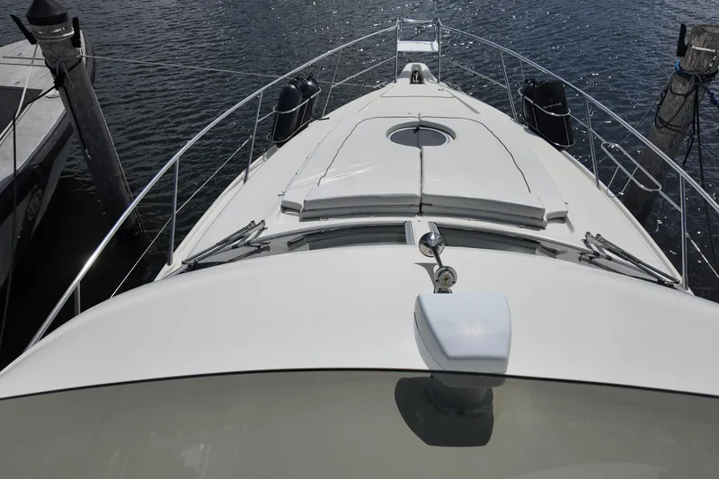 Slide: The Image of 2007 Cranchi Atlantique 40 yacht bow view, docked on calm water. - 8