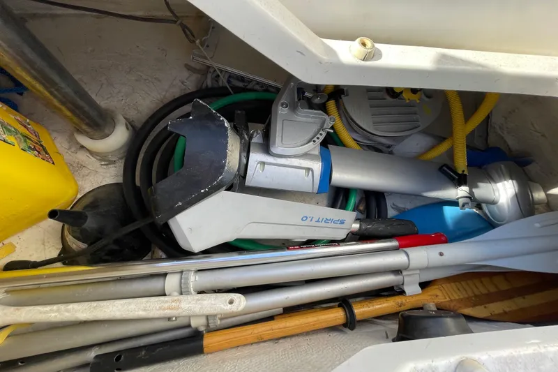 Slide: The Image of Storage compartment on a 1987 Beneteau 31 sailboat with various boating equipment. - 18