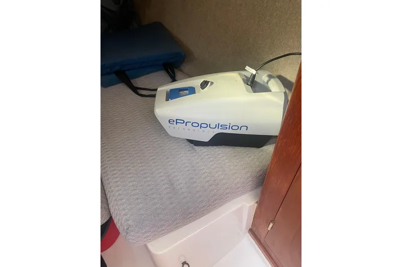 Slide: The Image of ePropulsion device inside 1987 Beneteau 31 boat cabin, resting on a cushioned surface. - 19