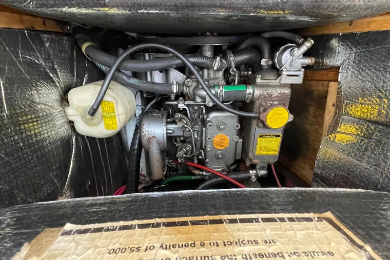 Slide: The Image of Engine compartment of a 1987 Beneteau 31 sailboat, showing detailed mechanical components. - 20