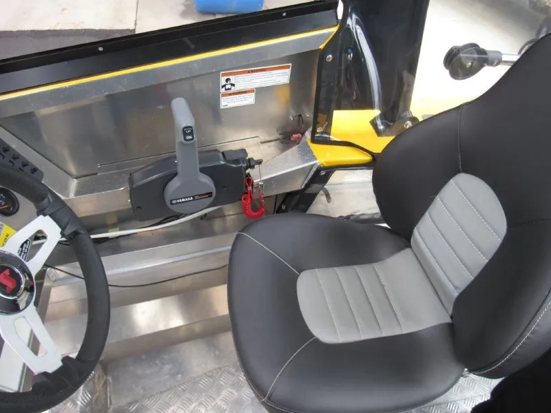 Slide: The Image of Interior of a 2021 Stabicraft 1550 Fisher with steering and seat. - 12
