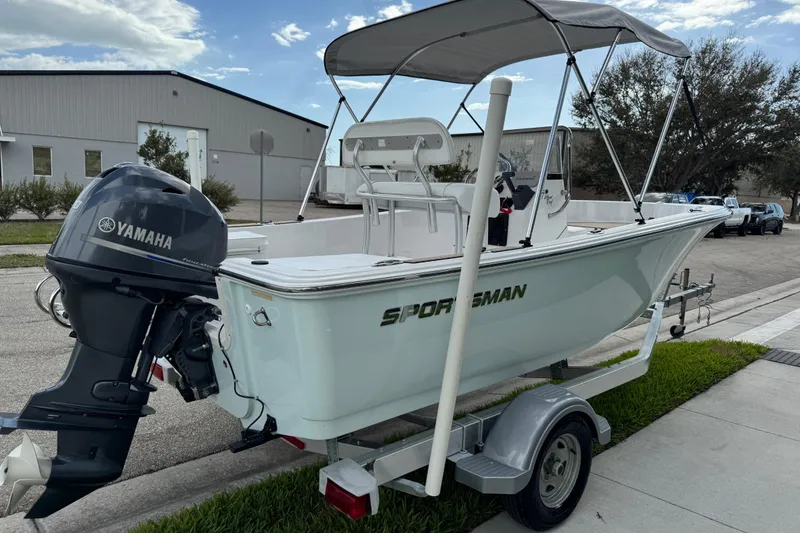 Slide: The Image of Trailer wheel of 2016 Sportsman Island Reef 17 Center Console on pavement. - 14