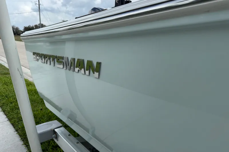 Slide: The Image of 2016 Sportsman Island Reef 17 Center Console boat deck with wood accents and stainless steel handle. - 17