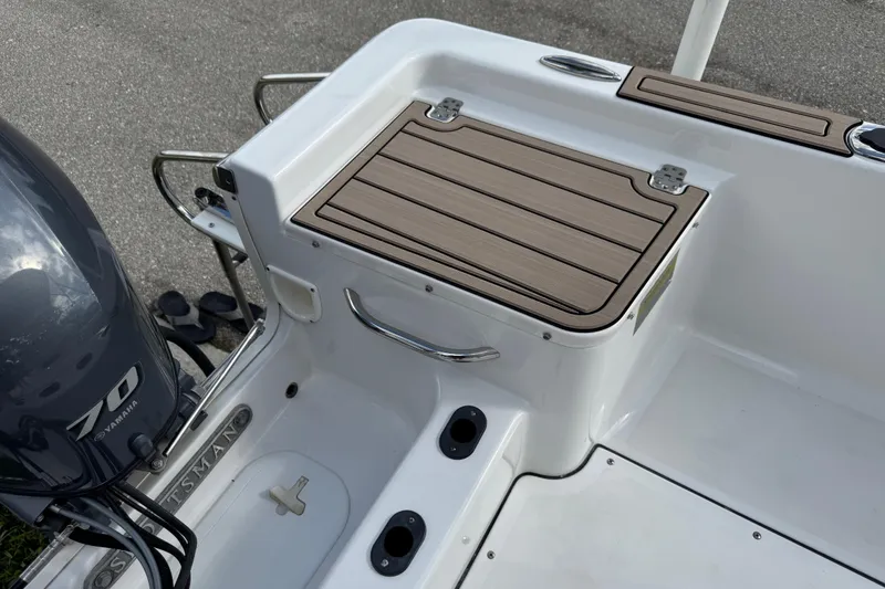 Slide: The Image of 2016 Sportsman Island Reef 17 Center Console boat with canopy, parked on a street. - 22