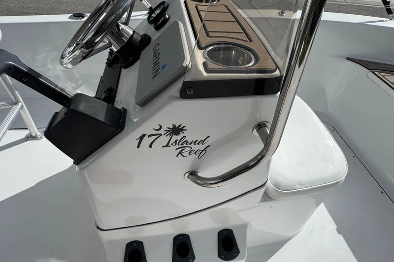 Slide: The Image of Control panel of a 2016 Sportsman Island Reef 17 Center Console boat with labeled switches. - 39