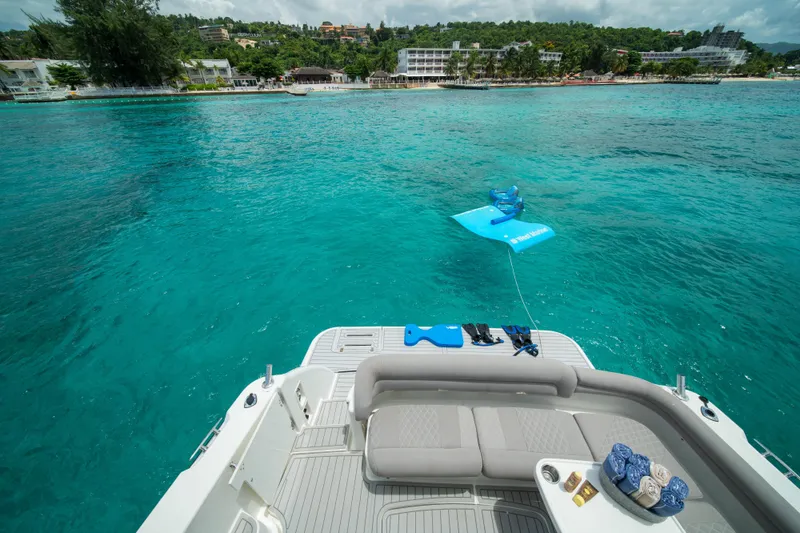 Slide: The Image of 2007 Tiara Yachts 4300 Sovran on turquoise waters near a scenic coastline. - 13