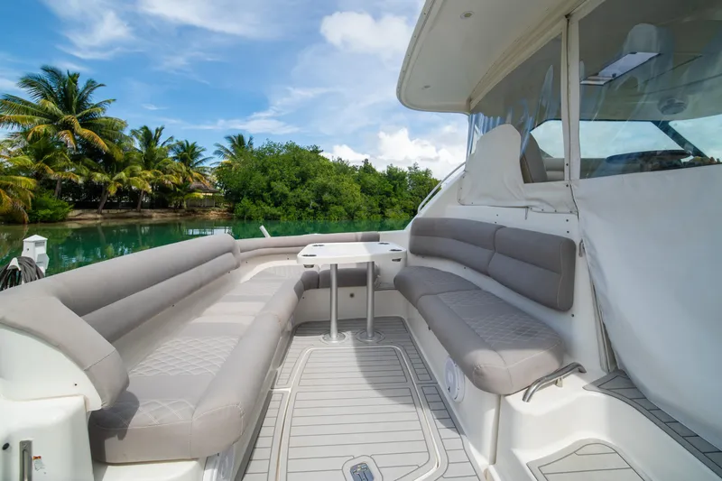 Slide: The Image of 2007 Tiara Yachts 4300 Sovran interior with plush seating, tropical backdrop. - 16
