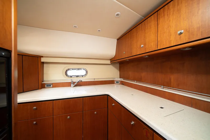 Slide: The Image of Luxurious 2007 Tiara Yachts 4300 Sovran kitchen with wood cabinetry and sleek countertops. - 4