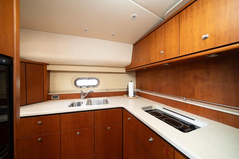 Slide: The Image of Luxurious 2007 Tiara Yachts 4300 Sovran kitchen with wood cabinetry and modern appliances. - 7