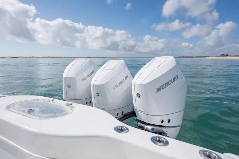 Slide: The Image of 2014 Yellowfin 42 Offshore boat with triple Mercury outboard engines on calm sea. - 14