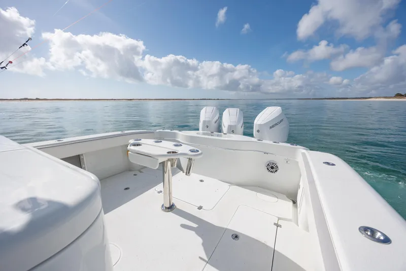 Slide: The Image of 2014 Yellowfin 42 Offshore boat with triple Mercury engines on calm water. - 15