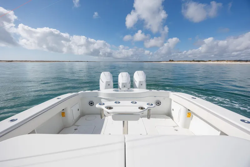 Slide: The Image of 2014 Yellowfin 42 Offshore boat on calm sea under blue sky with clouds. - 16
