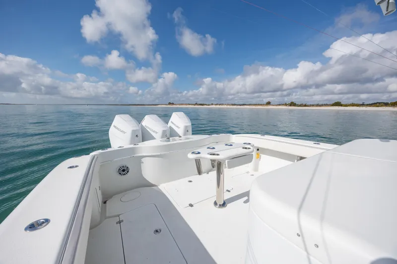 Slide: The Image of 2014 Yellowfin 42 Offshore boat with triple Mercury engines on calm water. - 17